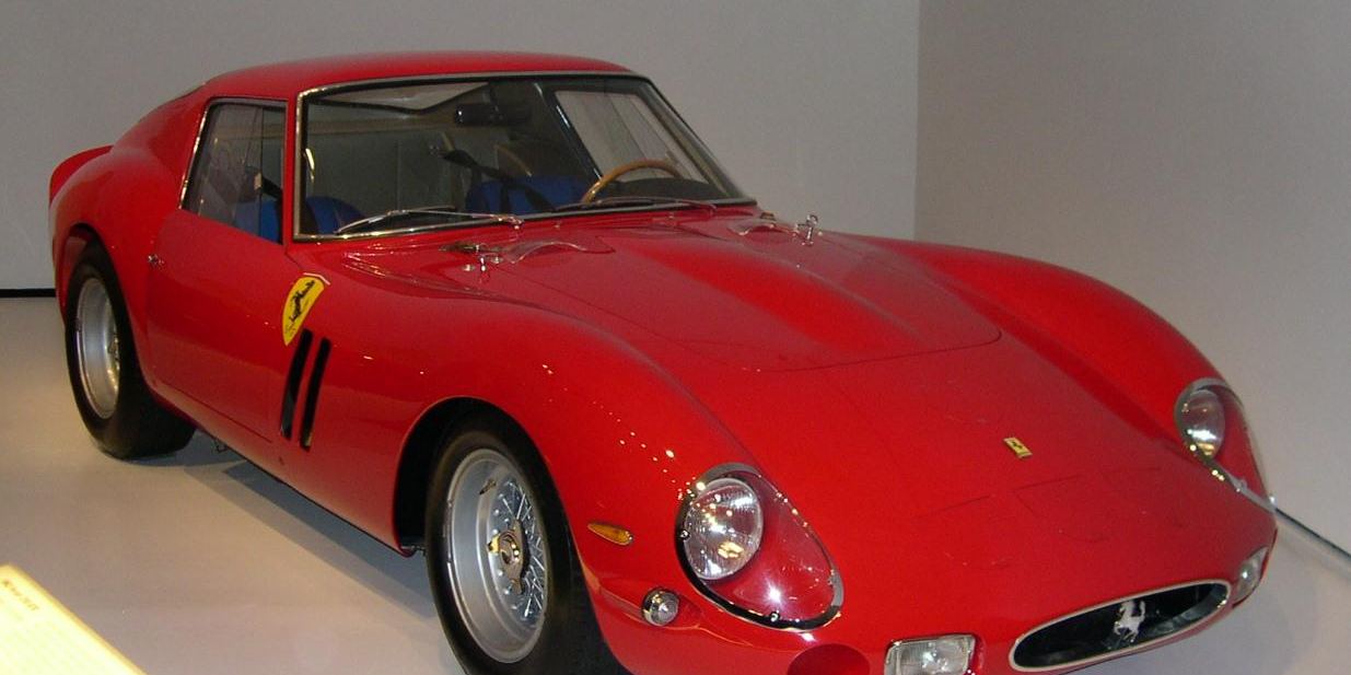 A red 1962 Ferrari 250 GTO coupe on display, seen from the front three-quarter angle