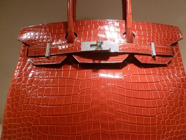 A glossy red crocodile leather Hermès Birkin bag with silver hardware