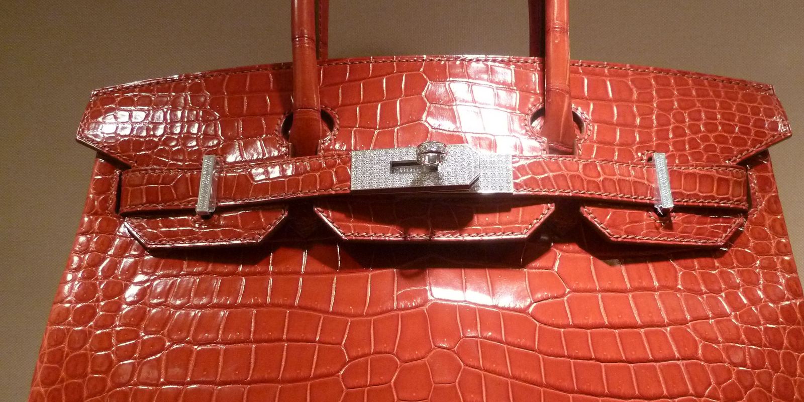 A glossy red crocodile leather Hermès Birkin bag with silver hardware